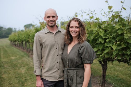 Owners of Bold North Cellars, from left, Tyler and Michelle Bredeson, stand in the vineyard at Carlos Creek Winery.